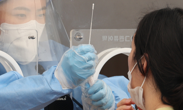 3일 서울역 임시선별진료소에서 한 시민이 검사를 받고 있다. 이날 0시 기준 코로나19 확진자는 11만9천922명이다. 4월 15일 이후 최다이다. 연합뉴스