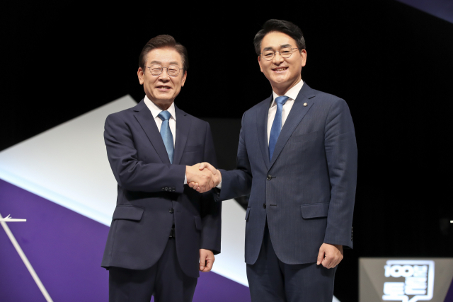 더불어민주당 당대표 선거에 나선 이재명, 박용진 후보가 지난 23일 서울 마포구 상암동 MBC에서 열린 100분 토론에 앞서 기념촬영을 하고 있다. 연합뉴스