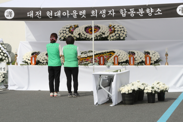 대전 현대아울렛 화재 사고 사흘째인 28일 오후 현장에 마련된 합동분향소에 아웃렛 직원들에게 건강음료를 배달하던 풀무원 테크노오피스 직원들이 추모하고 있다. 연합뉴스