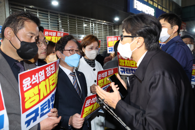 더불어민주당 박범계 윤석열정권정치탄압대책위원장과 의원들이 19일 서울 여의도 중앙당사 앞에서 민주연구원 압수수색에 나선 검찰 관계자들과 대치하고 있다. 연합뉴스