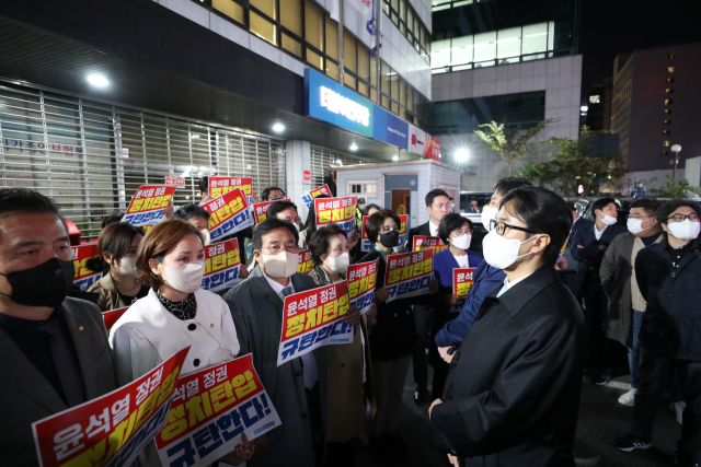 더불어민주당 의원들이 19일 서울 여의도 중앙당사 앞에서 민주연구원 압수수색에 나선 검찰 관계자들과 대치하고 있다. 연합뉴스