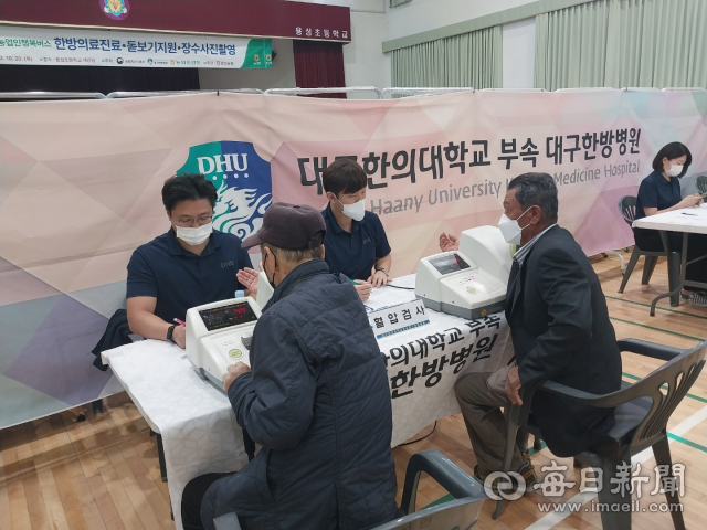 경산 용성농협은 20일 용성초등학교 대강당에서 농업인 행복버스 행사를 가졌다. 사진은 대구한의대병원 의료진이 농민들에게 한방진료를 하고 있는 모습. 용성농협 제공