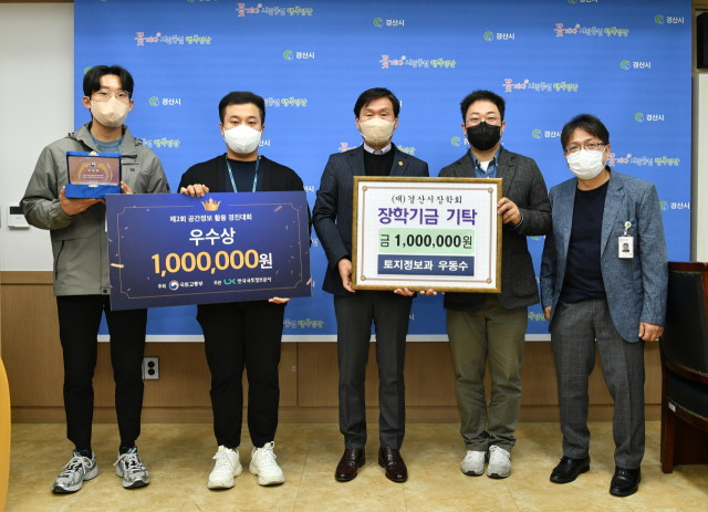 경산시 토지정보과 우동수 주무관(오른쪽 두번째)이 제2회 공간정보 활용 경진대회 우수상 시상금 100만원 전액을 경산시장학회에 기탁했다.