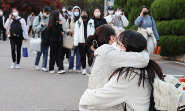 17일 오후 대입 수능 고사장인 선린인터넷고등학교에서 한 학부모가 시험을 보고 나온 딸과 만나고 있다. 연합뉴스