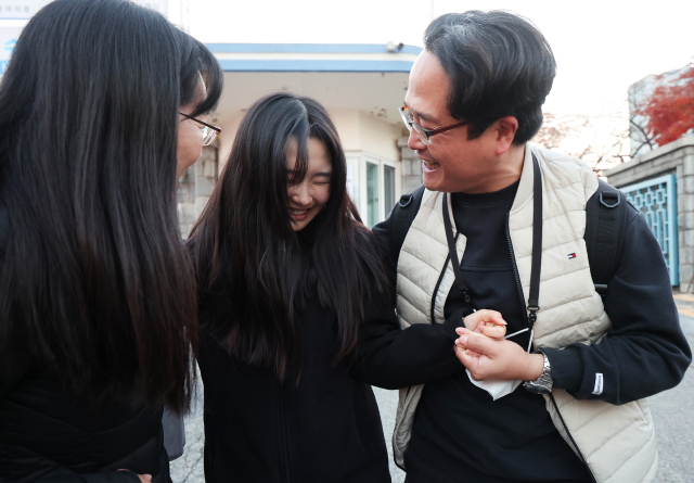 2023학년도 대학수학능력시험일인 17일 오후 경기도 수원시 팔달구 영복여자고등학교에서 학부모가 시험을 마치고 나온 수험생을 환하게 웃으며 안아주고 있다. 연합뉴스