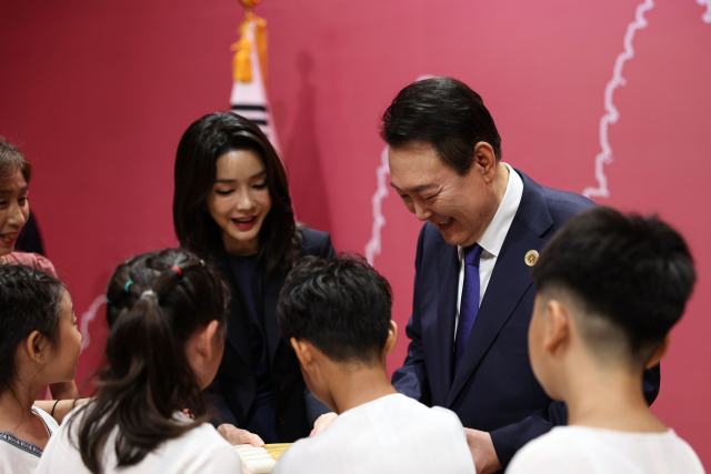 윤석열 대통령과 김건희 여사가 11일(현지시간) 캄보디아 프놈펜 한 호텔에서 열린 동포 만찬 간담회를 마친 뒤 라온제나 다문화가정 어린이 합창단원들로부터 떡빼빼로를 선물받고 있다. 연합뉴스