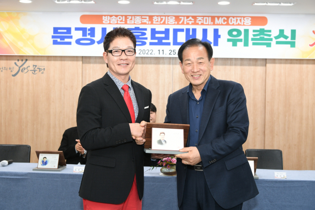신현국 문경시장이 MC여자용에게 문경시홍보대사 위촉패를 전달하고 있다.