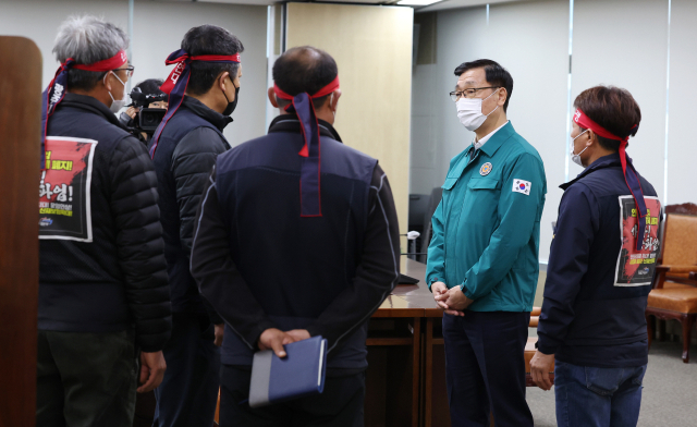 민주노총 공공운수노조 화물연대본부(이하 화물연대) 관계자들이 28일 오후 세종시 정부세종청사 국토교통부에서 총파업 시작 후 첫 교섭을 하기 위해 회의실에 입장해 어명소 국토교통부 제2차관(오른쪽 두번째)과 대화하고 있다. 연합뉴스