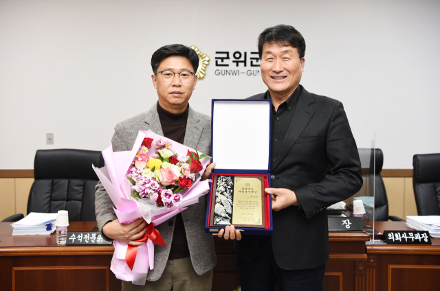 경북 군위군의회 서대식(왼쪽) 부의장이 박수현 군위군의회 의장으로부터 경상북도 의정봉사대상을 받고 기념 사진을 촬영하고 있다. 군위군의회 제공