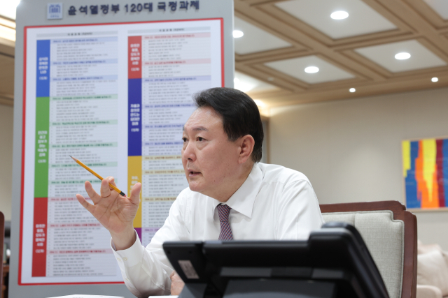 윤석열 대통령이 13일 윤석열정부 120대 국정과제 현황판이 설치된 용산 대통령실 청사 집무실에서 업무를 보고 있다. 연합뉴스