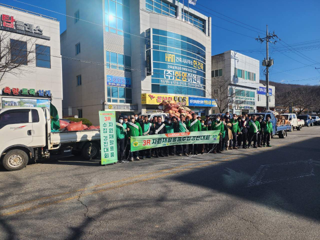 경북 군위군 새마을회가 개최한 자원재활용경진대회에 참여한 회원들이 새마을회관 앞에서 기념 사진을 촬영하고 있다. 군위군 제공