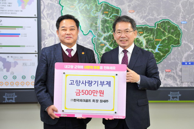 장세주(왼쪽) 한국파크골프 회장이 군위군에 고향사랑기부금 500만원을 기탁하고, 김진열(오른쪽) 군위군수와 기념 사진을 촬영하고 있다. 군위군 제공