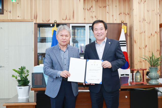 권태준(오른쪽) 청송군의회 의장으로부터 청송군의회 공무국외출장 심사위원회장으로 추대된 이재일 위원장이 위촉장을 받는 모습. 청송군의회 제공
