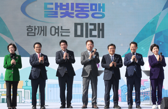 지난달 17일 오후 광주대구고속도로 지리산휴게소에서 열린 광주·대구 공항특별법 통시 통과 기념 및 달빛고속철도 예타면제 특별법 공동 추진 업무협약 행사에서 이인선(왼쪽부터), 김용판, 강대식, 송갑석, 이병훈, 이용빈, 양향자 의원이 축사를 마치고 손뼉 치고 있다. 연합뉴스
