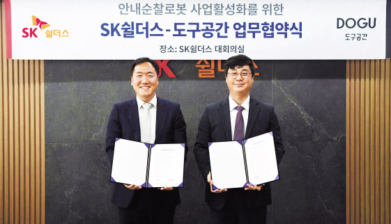 김윤호 SK쉴더스 성장추진실장과 김진효 도구공간 대표가 16일 안내순찰로봇 사업 협력을 위한 업무협약을 체결했다. SK쉴더스 제공.