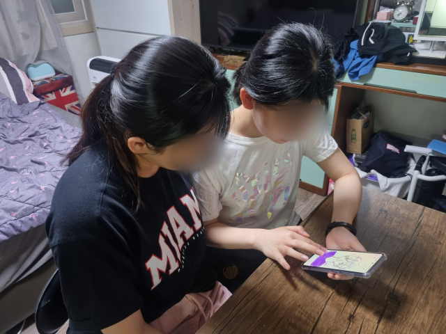 지난 19일 저녁 윤미소(가명·40) 씨의 딸 한초희(가명·15) 양이 휴대폰으로 그림을 그리고 있다. 윤정훈 기자