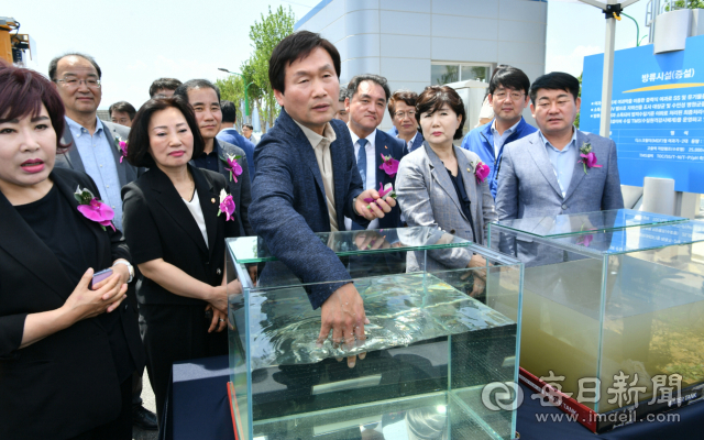 조현일 경산시장이 25일 경산시 공공하수처리장 증설공사 준공식에서 최종 방류수를 담은 유리상자 안에 직접 손을 넣어 수질을 확인해 보고 있다. 경산시 제공