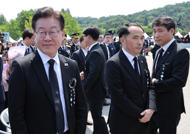 더불어민주당 이재명 대표(왼쪽)가 6일 서울 동작구 국립서울현충원에서 열린 제68회 현충일 추념식장에서 최원일 전 천안함장(가운데)으로부터 항의를 받은 뒤 돌아서고 있다. 연합뉴스
