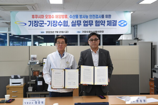 정종복(왼쪽) 기장군수와 문용환 기장수협조합장이 21일 방사능 검사 업무협약을 체결한 뒤 기념사진을 찍고 있다. 기장군 제공