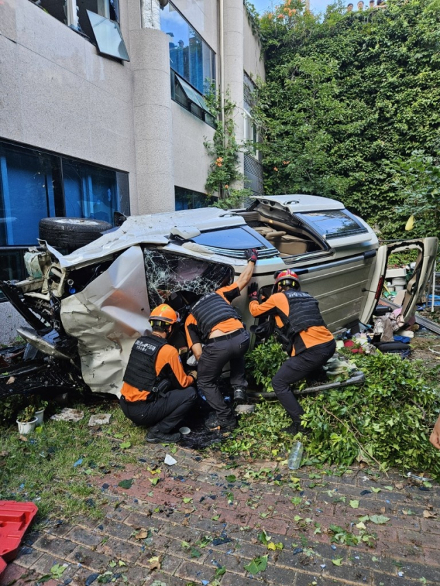 지난 12일 오후 5시 1분쯤 경북 안동시 송현동 한 내리막길에서 카니발 승합차량이 도로 난간을 뚫고 6m 아래로 추락하는 사고가 발생했다. 사진은 구조대원들이 차량 내 탑승자를 구조하는 모습. 안동소방서 제공