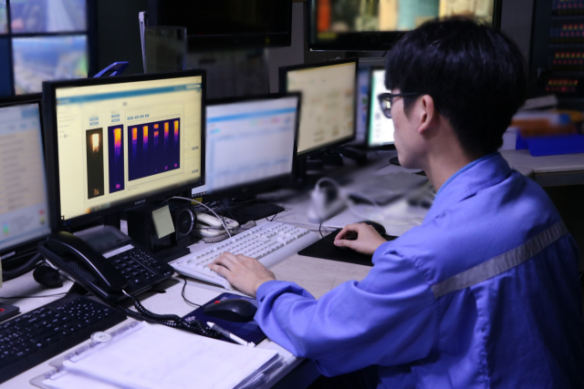 포항제철소에서 한 작업자가 코크스오븐 자동 연소 제어 시스템을 활용해 적정 연소량을 조절하고 있다. 포스코 제공