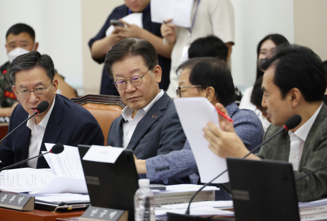 더불어민주당 이재명 대표가 21일 국회에서 열린 국방위원회 전체회의에 출석, 동료 의원들과 대화를 하고 있다. 연합뉴스