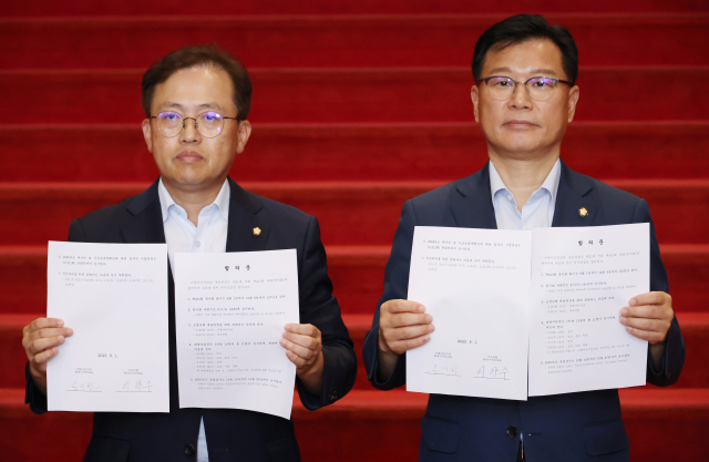 1일 국회에서 국민의힘 이양수 원내수석부대표(오른쪽)와 더불어민주당 송기헌 원내수석부대표가 정기국회 의사일정에 합의한 뒤 합의문을 보여주고 있다. 연합뉴스