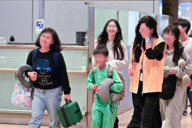 우리 교민들이 텔아비브 공항에서 외교부 신속대응팀 인원(노란 조끼 착용)을 만나자 환하게 웃고 있다. 연합뉴스