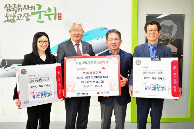 강윤구 대구지방변호사회 회장이 군위군에 전기요를 전달하고, 김진열 군수와 기념 사진을 촬영하고 있다. 군위군 제공