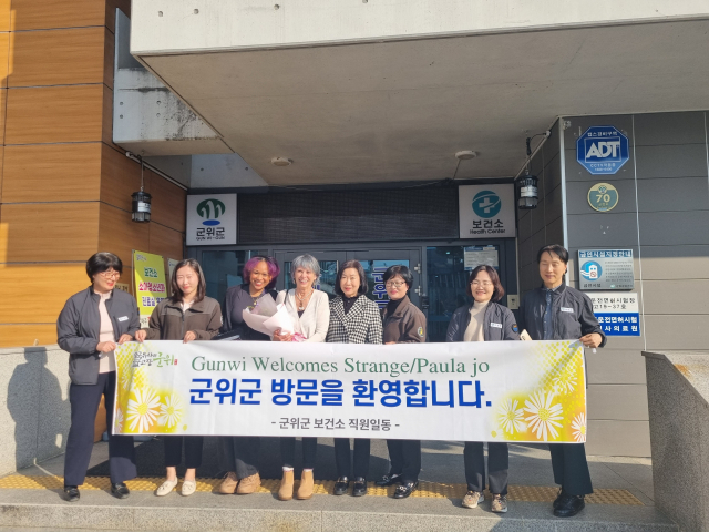 1980년 미국 평화봉사단원으로 군위군 보건소에 근무한 스트레인지 파울라 조 씨가 딸과 함께 군위군을 방문, 보건소 직원들과 기념 사진을 촬영하고 있다. 군위군 제공