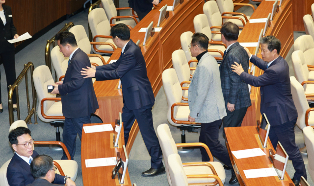 9일 국회에서 열린 본회의에서 더불어민주당 의원들이 퇴장하고 있다. 이날 본회의에서 
