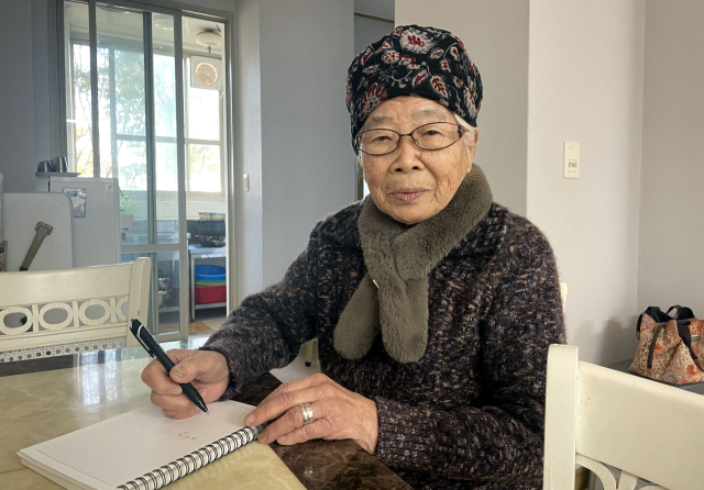 청도온누리대학 최고령 학습자 이이갑(98) 할머니가 펜을 잡고 배움의 뜻을 전하고 있다.