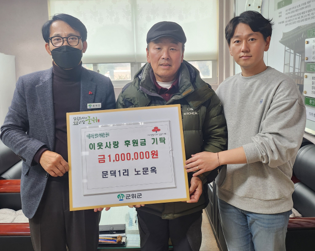 대구 군위군 우보면에 이웃사랑 나눔 행렬이 이어지고 있는 가운데 노문옥 씨가 우보면에 성금 100만원을 기탁하고, 기념 사진을을 촬영하고 있다. 군위군 제공