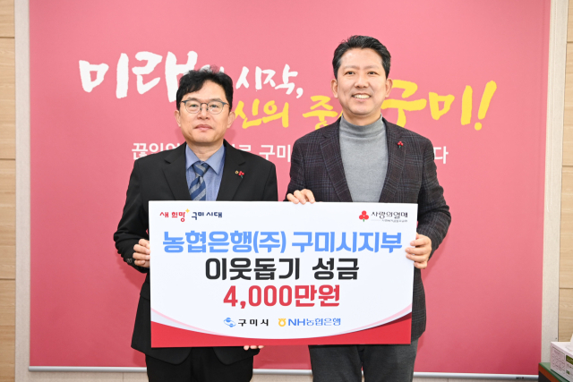 이재호(왼쪽) NH농협은행 구미시지부장이 지난 21일 김장호 구미시장에게 이웃돕기 성금 4천만원을 전달한 뒤 기념촬영을 하고 있다. NH농협은행 구미시지부 제공