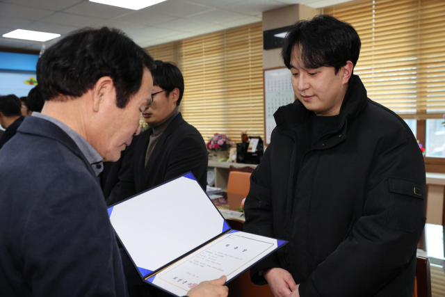 김주수 의성군수(왼쪽)가 한 수의사에게 공수의 위촉장을 수여하고 있다. 의성군 제공