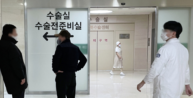 전공의들의 대규모 사직으로 의료공백이 현실화하는 가운데 21일 오후 서울의 한 대형병원 수술실 앞에 환자 보호자들이 대기하고 있다. 이날 의료계에 따르면 