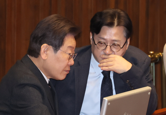 더불어민주당 이재명 대표와 홍익표 원내대표가 21일 국회에서 열린 본회의에서 대화하고 있다. 연합뉴스