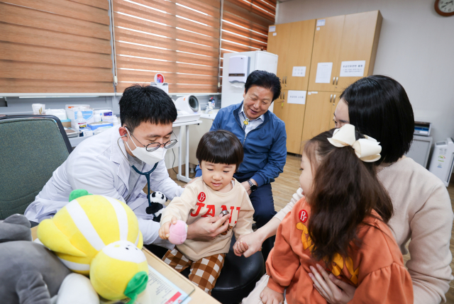 성주보건소 소아청소년 진료과에서 소아청소년 전문의가 어린이 환자를 진료하고 있다. 첫 진료 장면을 이병환 성주군수가 관심있게 지켜보고 있다. 성주군 제공