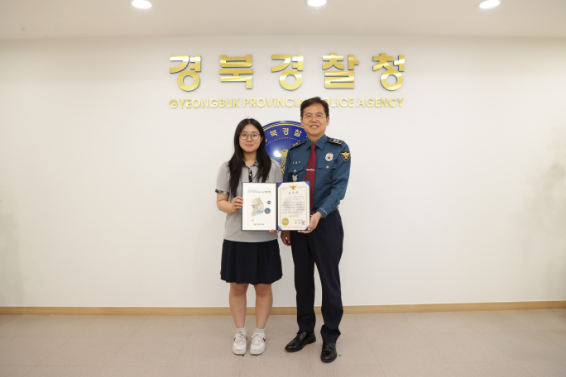 포항중앙여고 김은양(18) 양이 김철문 경북경찰청에게 감사장을 받고 기념촬영을 하고 있다. 경북경찰청 제공