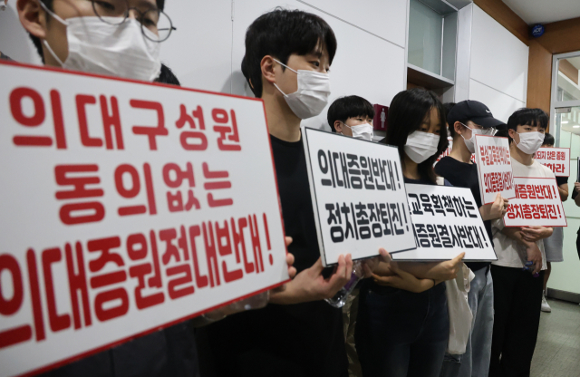 충북대 의대 교수·학생 등 50여명이 21일 오후 학칙개정안을 심의하는 교무회의가 열리는 충북대학교 대학본부 5층 대회의실 앞 복도에서 증원 반대 시위를 하고 있다. 연합뉴스