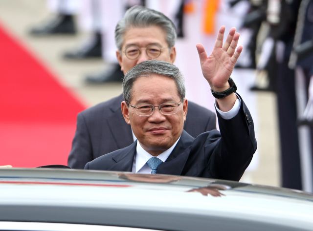 리창 중국 총리가 한중일 정상회의를 하루 앞둔 26일 경기도 성남 서울공항에 도착해 손을 흔들고 있다. 연합뉴스