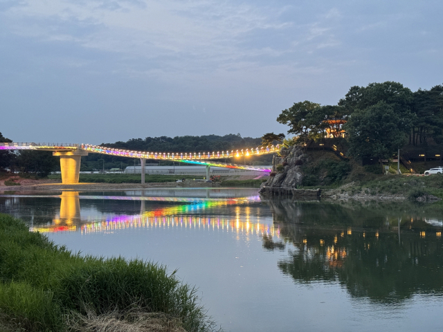 해가 저물자 문경 영강보행교 출렁다리의 경관조명이 영강에 투영되고 있다. 문경시 제공