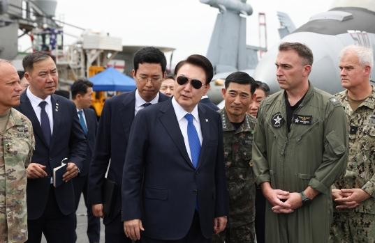 2024년 6월 25일 당시 윤석열 대통령이 부산 해군작전기지에서 미 해군 항공모함 시어도어 루즈벨트함에 승선해 비행 갑판을 시찰하고 있다. 연합뉴스