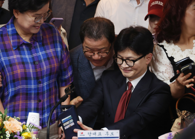 국민의힘 당권주자인 한동훈 전 비상대책위원장이 27일 대구 서구 김상훈 의원 지역구 사무실 건물 한 회의실에서 당원들과 기념 촬영을 하고 있다. 연합뉴스