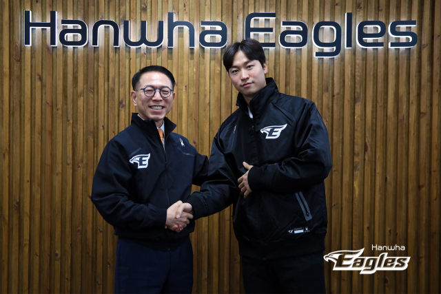 투수 엄상백(오른쪽)이 8일 대전 중구 한화 이글스파크에서 한화 이글스와 FA 계약을 한 후 박종태 대표이사와 악수하고 있다. 연합뉴스