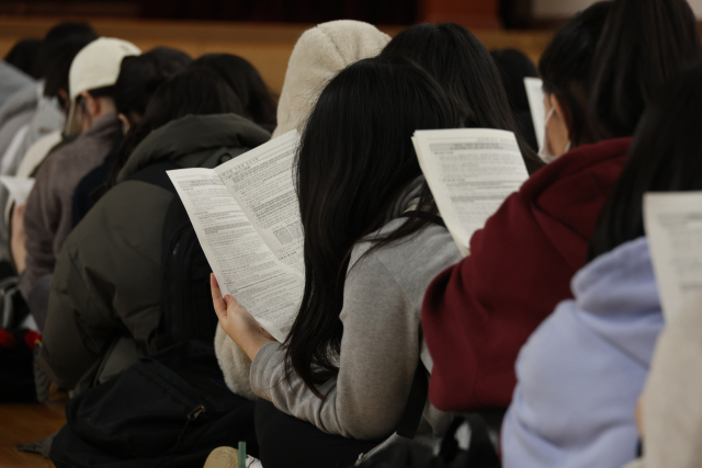 2025학년도 대학수학능력시험 예비소집일인 13일 대구 수성고등학교 체육관에서 수험생들이 유의 사항을 살펴보고 있다. 연합뉴스