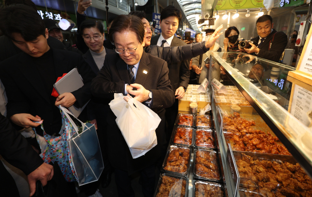 더불어민주당 이재명 대표가 1일 오후 경북 포항시 죽도시장을 찾아 닭튀김을 사고 있다. 연합뉴스