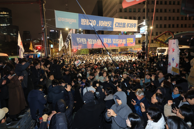 윤석열 대통령이 비상계엄을 선포한 가운데 4일 자정쯤 서울 여의도 국회의사당 앞에서 시민들이 계엄 해제 구호를 외치고 있다. 연합뉴스