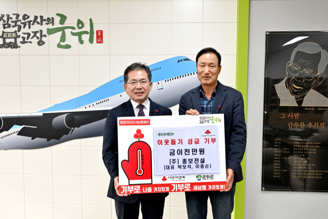 박보석(오른쪽) ㈜종보건설 대표가 김진열 군위군수에게 이웃사랑 성금 2천만원을 기탁하고, 기념 사진을 촬영하고 있다. 군위군 제공