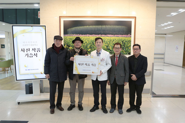 작품 기증식 후 촬영한 단체사진. 왼쪽에서 두 번째가 강윤덕 작가, 세 번째가 김종연 영남대의료원장. 영남대의료원 제공.